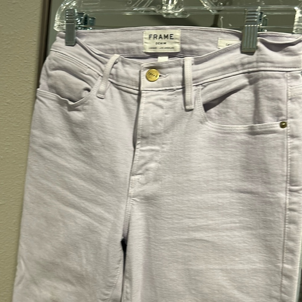 Frame skinny jeans with frayed hem in pale lavender.
